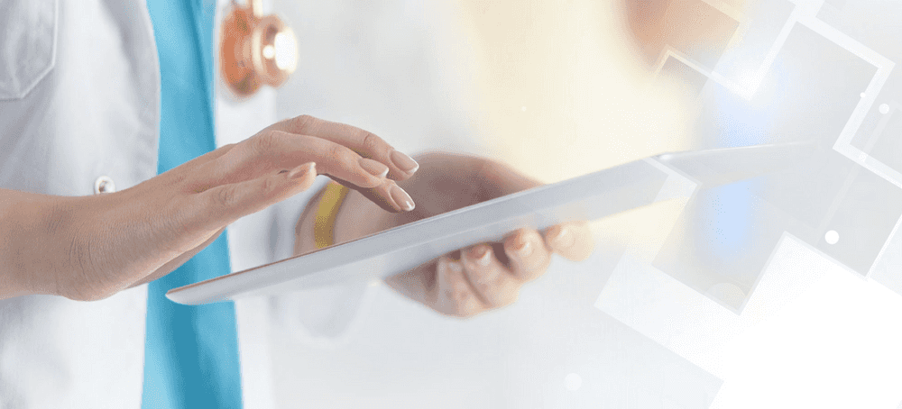 a doctor typing in medical record notes on a tablet